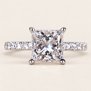 Princess cut lab grown diamond engagement ring in white gold with four-prong center and round pavé-set shoulders