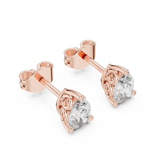 Side profile of rose gold pear-shaped solitaire diamond studs.