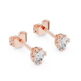 Side profile of rose gold oval cut solitaire diamond studs.