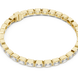 Gold bracelet with clear stones on a white background