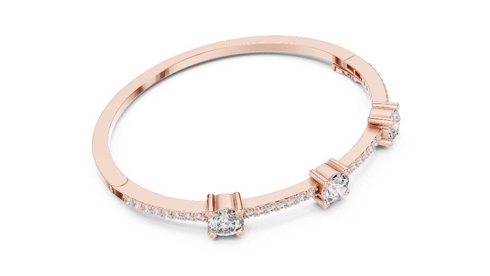 Elegant three stone round diamond bangle bracelet in gold with pavé accent diamonds by Signora Jewels