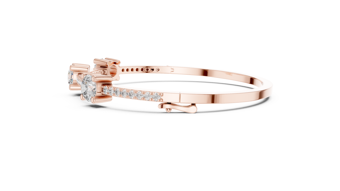 Elegant three stone round diamond bangle bracelet in gold with pavé accent diamonds by Signora Jewels