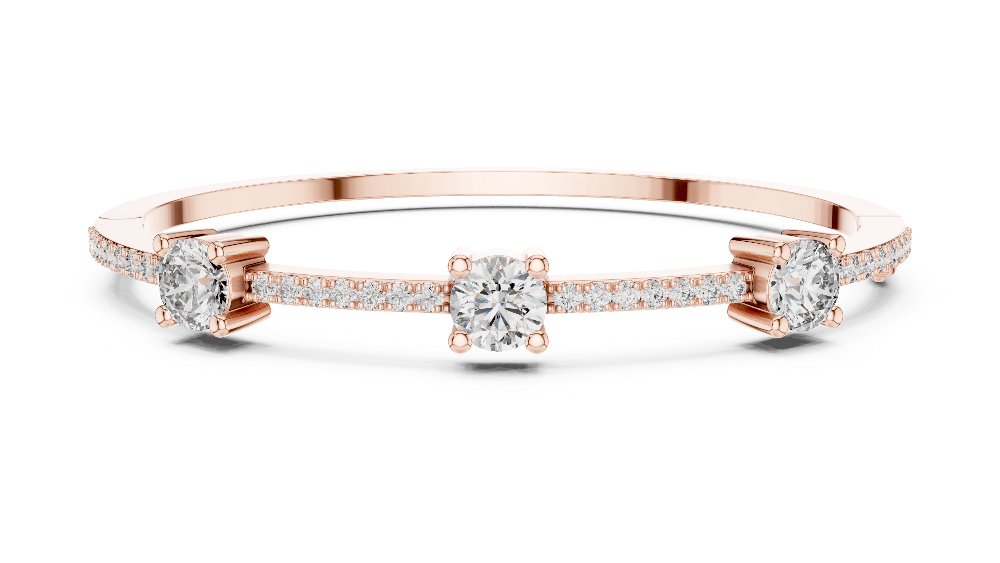 Elegant three stone round diamond bangle bracelet in gold with pavé accent diamonds by Signora Jewels