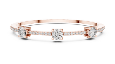 Elegant three stone round diamond bangle bracelet in gold with pavé accent diamonds by Signora Jewels