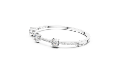 Elegant three stone round diamond bangle bracelet in gold with pavé accent diamonds by Signora Jewels