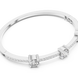 Elegant three stone round diamond bangle bracelet in gold with pavé accent diamonds by Signora Jewels