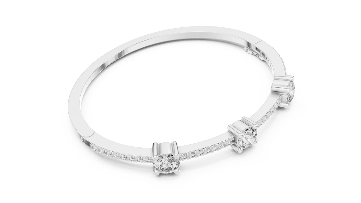 Elegant three stone round diamond bangle bracelet in gold with pavé accent diamonds by Signora Jewels