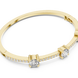 Elegant three stone round diamond bangle bracelet in gold with pavé accent diamonds by Signora Jewels