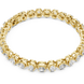 Gold bracelet with clear stones on a white background