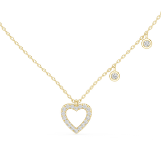 Gold necklace with a heart-shaped pendant on a white background