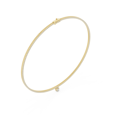 Gold necklace with a small round pendant on a white background