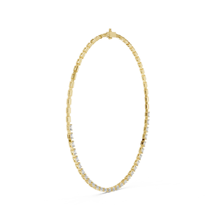 Gold necklace with small diamonds on a white background