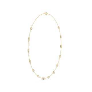 Gold necklace with small beads on a white background