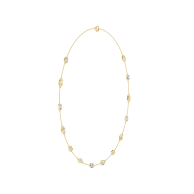 Gold necklace with small beads on a white background