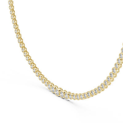 Gold necklace with clear stones on a white background