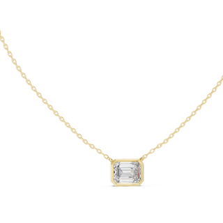 Emerald cut east-west lab grown diamond bezel pendant in yellow gold