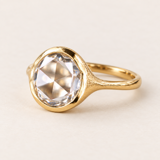 Round rose cut lab grown diamond bezel engagement ring in yellow gold with a continuous rim and textured tapered shoulders