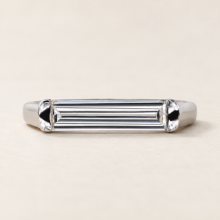 East-west baguette lab grown diamond bezel engagement ring in white gold with rounded metal end caps and a plain polished band