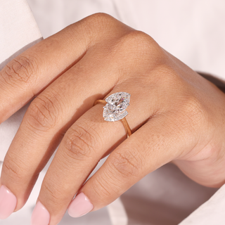 Marquise lab grown diamond bypass engagement ring in yellow gold with two curved pavé accents.