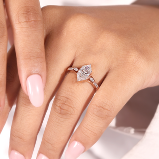 Rose gold marquise lab grown diamond engagement ring with two marquise side stones and four round accents.