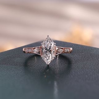 Rose gold marquise lab grown diamond engagement ring with two marquise side stones and four round accents.