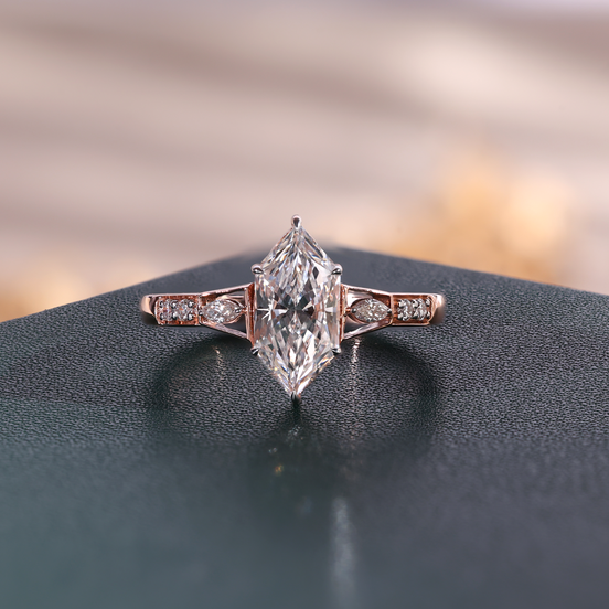 Rose gold marquise lab grown diamond engagement ring with two marquise side stones and four round accents.