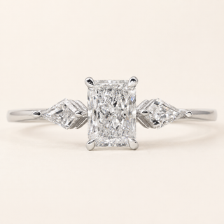 Radiant cut Lab Grown Diamond three-stone engagement ring in white gold with kite side diamonds and plain shank