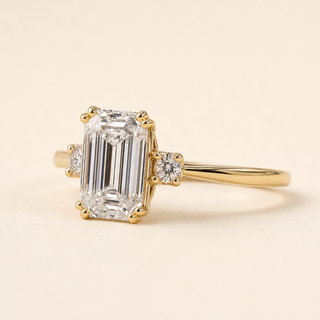 Emerald Cut Lab Grown Diamond Three-Stone Engagement Ring with Tapered Baguette Side Diamonds in Yellow Gold