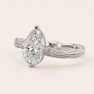 Oval Lab Grown Diamond nature inspired engagement ring in white gold with a twisted vine shank and four-prong cathedral setting.