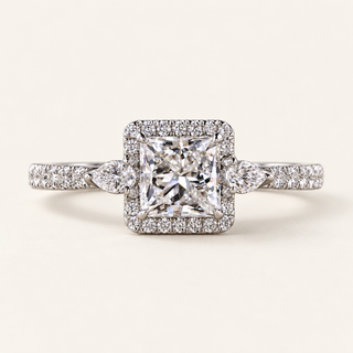 Princess cut lab grown diamond halo engagement ring with 0.80 ct center, square pavé halo, pear-shaped side diamonds and pavé shoulders in polished white gold.