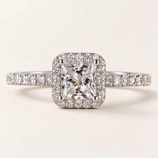 Princess cut lab grown diamond halo engagement ring in white gold with square center, rounded prongs and pavé diamond shoulders