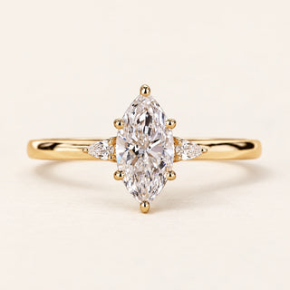 Marquise cut lab grown diamond three-stone engagement ring with pear side diamonds in yellow gold