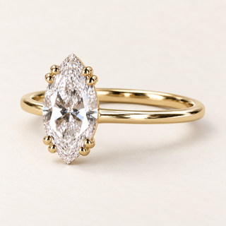 Marquise lab grown diamond engagement ring in yellow gold with eight rounded prongs in four pairs and a plain polished band