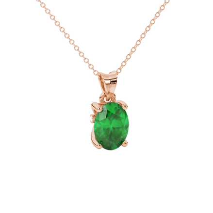 Close-up, oval cut emerald green gemstone pendant, rose gold surprise diamond setting.