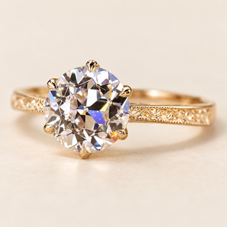 Old European cut Lab Grown Diamond vintage engagement ring in yellow gold with a six-prong lotus basket and engraved milgrain band.