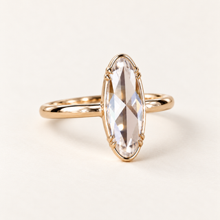 Moval rose cut lab grown diamond solitaire engagement ring in yellow gold with perimeter rails, paired side prongs and a plain band
