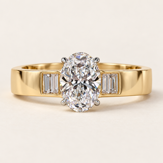 Oval cut lab grown diamond engagement ring with 1.00 ct center, four vertically aligned baguette diamond accents and broad polished yellow gold shoulders.