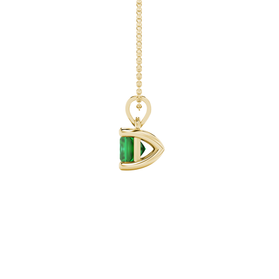 Side profile, yellow gold emerald green pendant, classic basket gallery.