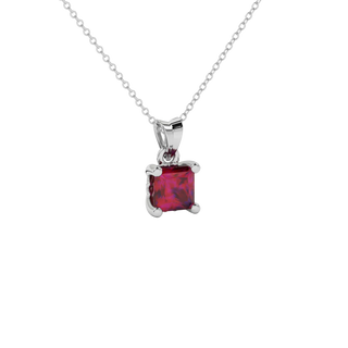 Close-up raspberry red gemstone, white gold lotus setting.