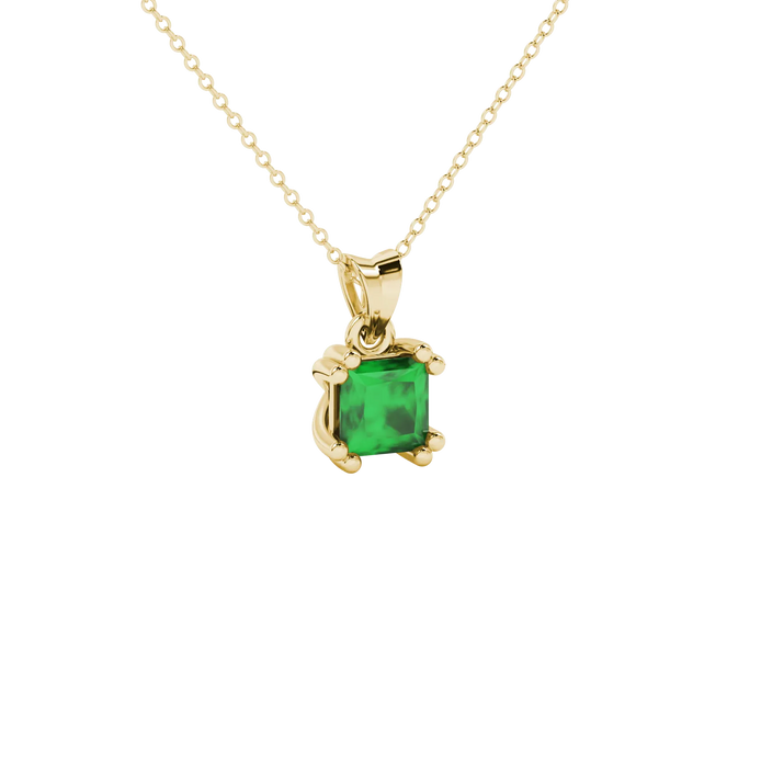 Close-up, princess emerald green gemstone, yellow gold vintage pendant.