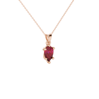 Close-up, pear shape raspberry red gemstone pendant, rose gold six-prong basket.