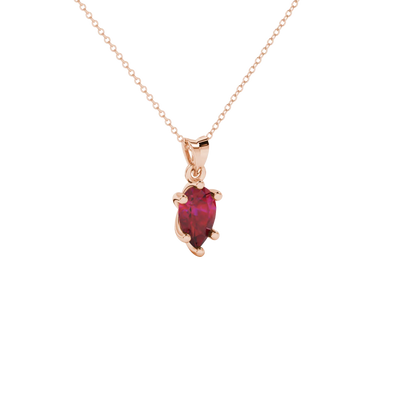 Close-up, pear shape raspberry red gemstone pendant, rose gold six-prong basket.