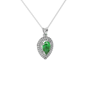 Close-up emerald green gemstone pendant, white gold halo setting.