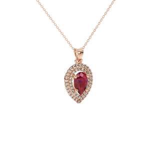 Close-up, pear shape raspberry red gemstone pendant, rose gold halo setting.