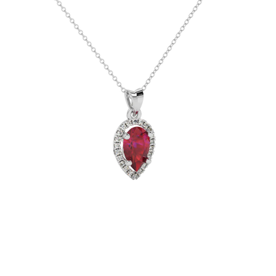 Close-up raspberry red gemstone pendant, white gold french pavé halo.