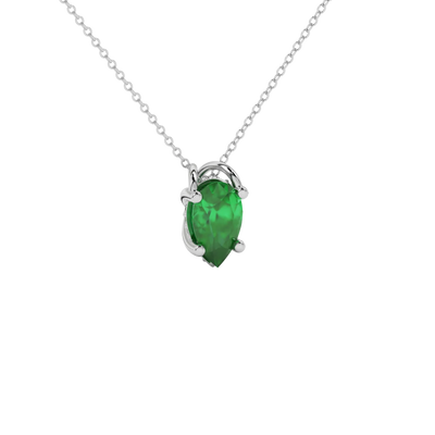 Close-up emerald green gemstone, white gold pavé basket.