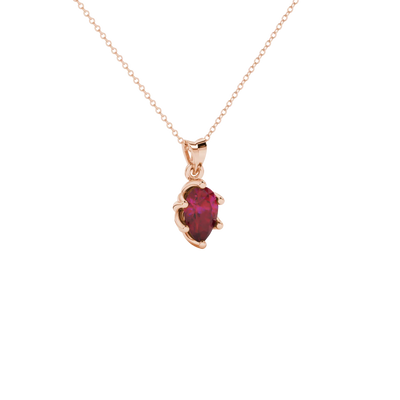 Close-up, pear shape raspberry red gemstone pendant, rose gold scalloped setting.