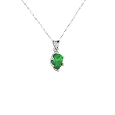 Close-up emerald green gemstone, white gold scalloped setting.