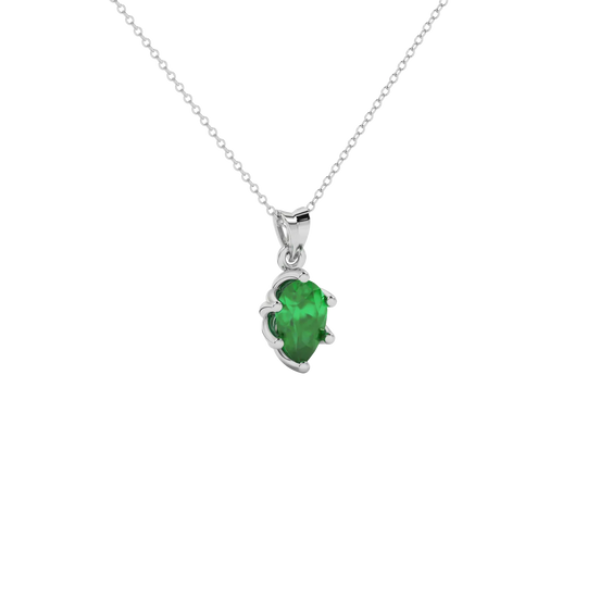 Close-up emerald green gemstone, white gold scalloped setting.