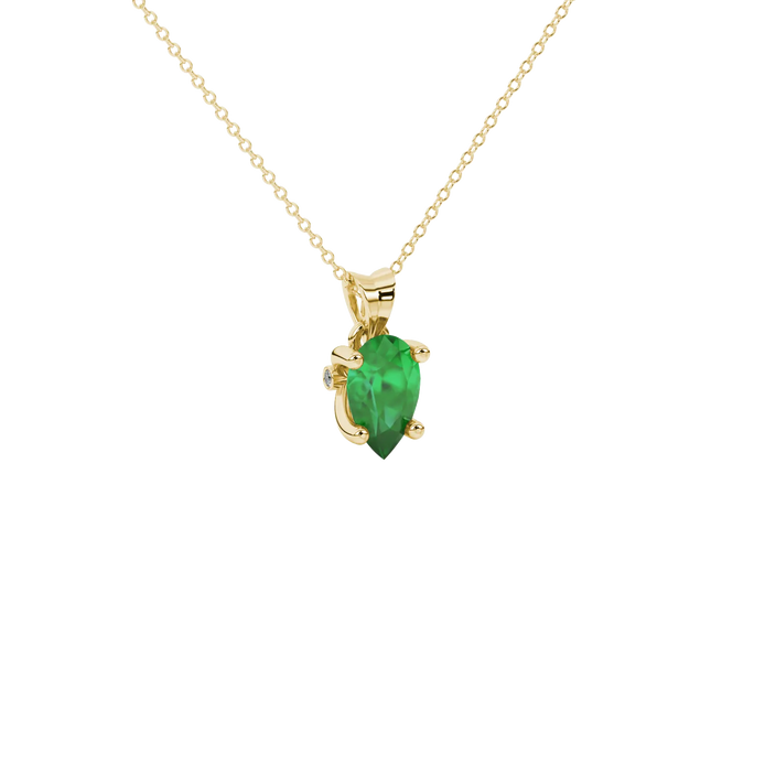 Close-up, pear shape emerald green gemstone, yellow gold surprise diamond pendant.